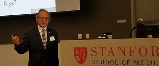Michael Levitt (Nobel Prize winner) giving presentation in front of large screen